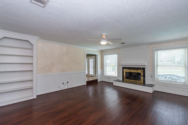 6310 Gleneagles Dr, Pasadena, TX 77505 - unfurnished living room with dark wood finished floors, a textured ceiling, a high end fireplace, a ceiling fan, and crown molding