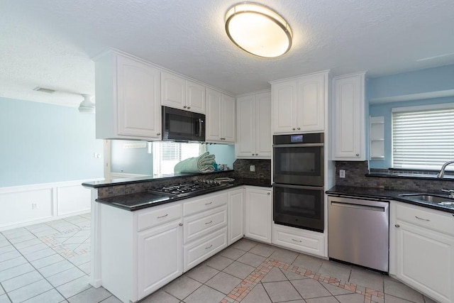 6310 Gleneagles Dr, Pasadena, TX 77505 - kitchen featuring stainless steel dishwasher, double wall oven, black microwave, light tile patterned floors, and a textured ceiling