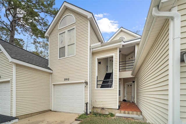 3317 Golden Trails Dr Unit 802, Houston, TX 77345 - view of front of house with concrete driveway, a garage, and a balcony