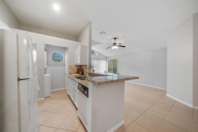 3317 Golden Trails Dr Unit 802, Houston, TX 77345 - kitchen featuring white appliances, light tile patterned floors, a peninsula, white cabinetry, and vaulted ceiling