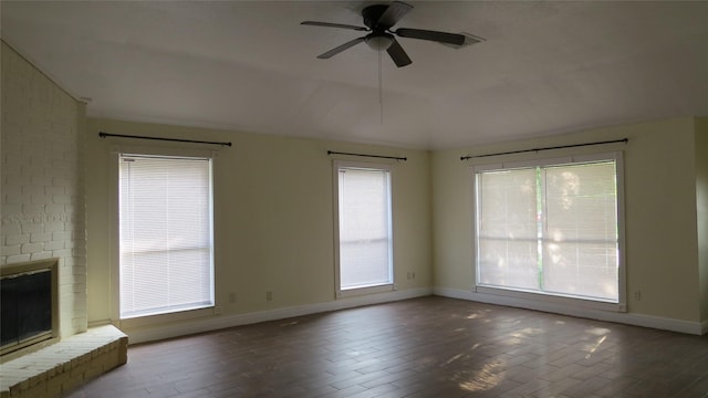 2223 Sentinal Oaks St, Sugar Land, TX 77478 - unfurnished living room featuring baseboards, lofted ceiling, ceiling fan, a brick fireplace, and wood finished floors
