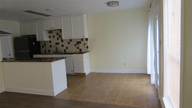 2223 Sentinal Oaks St, Sugar Land, TX 77478 - kitchen featuring white dishwasher, fridge, dark countertops, white cabinets, and tasteful backsplash