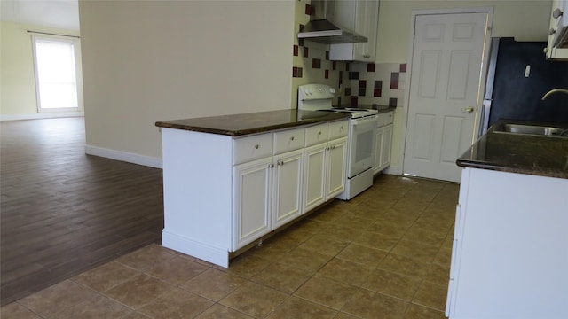 2223 Sentinal Oaks St, Sugar Land, TX 77478 - kitchen featuring white electric range, wall chimney range hood, a sink, dark countertops, and white cabinetry