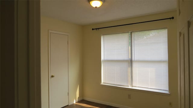 2223 Sentinal Oaks St, Sugar Land, TX 77478 - empty room with baseboards and dark wood-style flooring