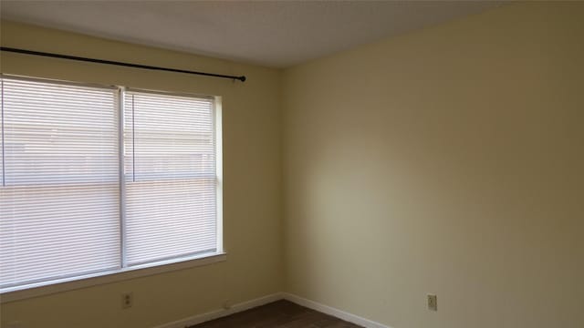 2223 Sentinal Oaks St, Sugar Land, TX 77478 - spare room featuring baseboards, dark wood-style flooring, and healthy amount of natural light