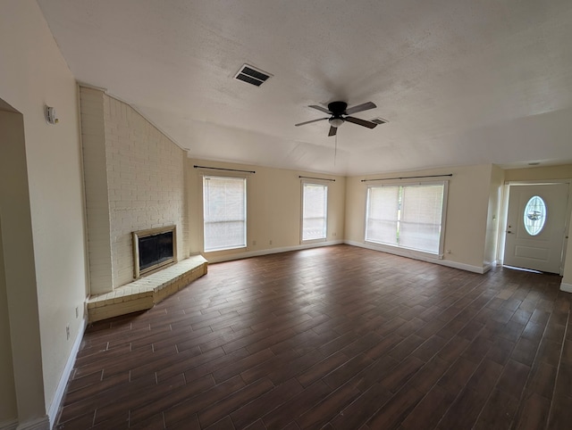 2223 Sentinal Oaks St, Sugar Land, TX 77478 - unfurnished living room featuring a ceiling fan, baseboards, dark wood finished floors, plenty of natural light, and a textured ceiling