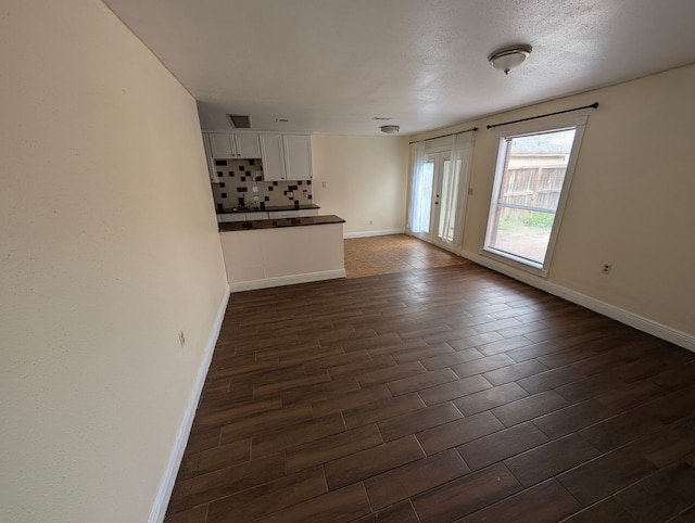 2223 Sentinal Oaks St, Sugar Land, TX 77478 - unfurnished living room with baseboards and dark wood-style floors