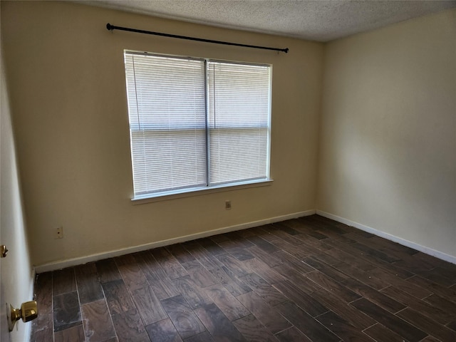 2223 Sentinal Oaks St, Sugar Land, TX 77478 - unfurnished room with healthy amount of natural light, dark wood-type flooring, baseboards, and a textured ceiling