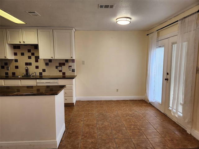 2223 Sentinal Oaks St, Sugar Land, TX 77478 - kitchen with a sink, dark countertops, baseboards, backsplash, and dark tile patterned flooring