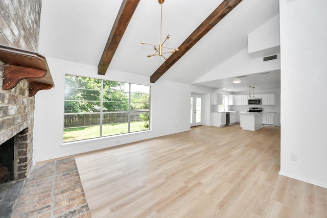 3223 Deer Valley Dr, Spring, TX 77373 - unfurnished living room featuring a chandelier, light wood-type flooring, a fireplace, high vaulted ceiling, and beamed ceiling