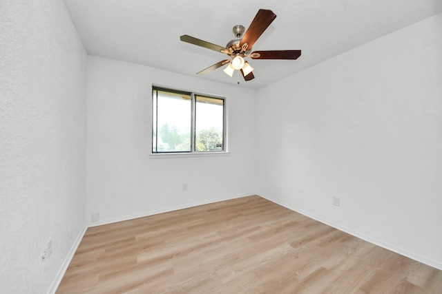 3223 Deer Valley Dr, Spring, TX 77373 - empty room with light wood-style floors, a ceiling fan, and baseboards