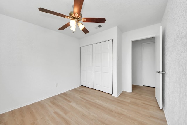 3223 Deer Valley Dr, Spring, TX 77373 - unfurnished bedroom featuring light wood-style floors, a closet, a ceiling fan, and baseboards