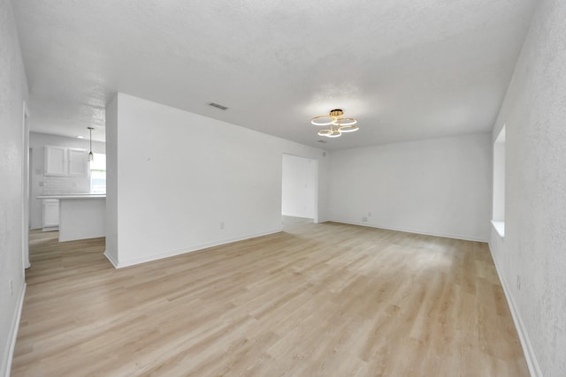 3223 Deer Valley Dr, Spring, TX 77373 - unfurnished room with a chandelier, light wood finished floors, and baseboards