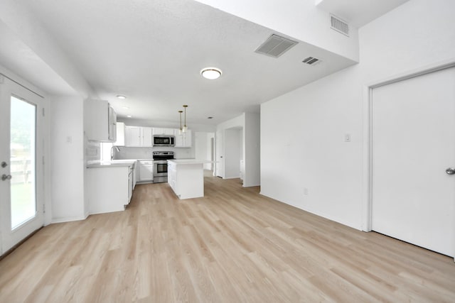3223 Deer Valley Dr, Spring, TX 77373 - unfurnished living room featuring light wood finished floors, a sink, and baseboards