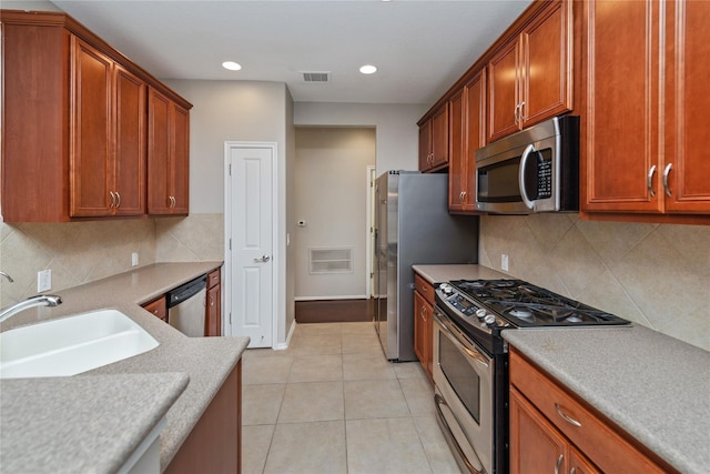 13600 Breton Ridge St Unit 24A, Houston, TX 77070 - kitchen featuring stainless steel appliances, a sink, light countertops, decorative backsplash, and recessed lighting