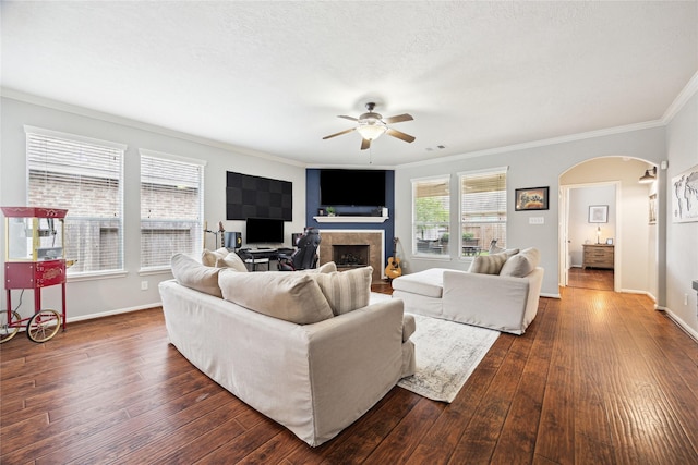 2304 Cantabria Ln, League City, TX 77573 - living area featuring arched walkways, a ceiling fan, dark wood finished floors, crown molding, and baseboards