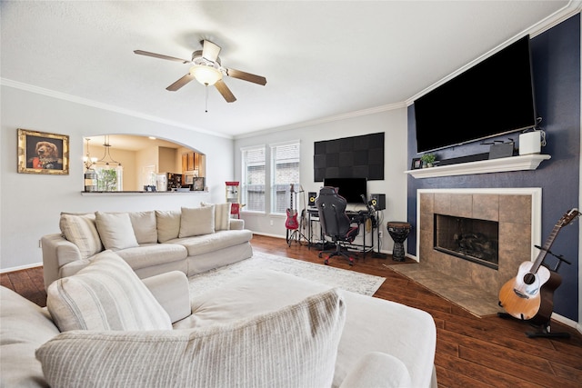 2304 Cantabria Ln, League City, TX 77573 - living area featuring crown molding, ceiling fan, a fireplace, wood finished floors, and baseboards