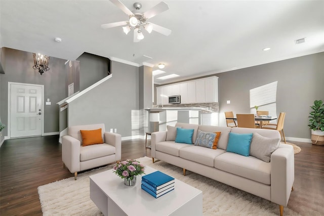 17139 Oakwood Chase Dr, Spring, TX 77379 - living area with baseboards, a ceiling fan, wood finished floors, crown molding, and a chandelier