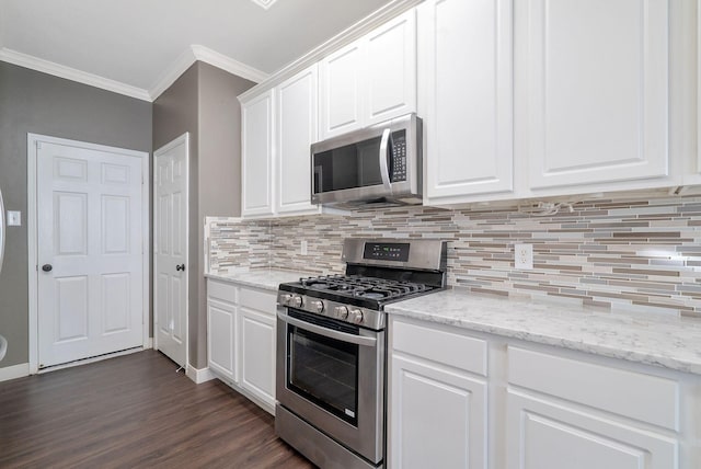 17139 Oakwood Chase Dr, Spring, TX 77379 - kitchen featuring stainless steel appliances, crown molding, decorative backsplash, dark wood-type flooring, and white cabinets