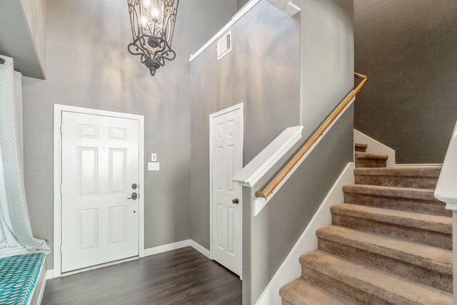 17139 Oakwood Chase Dr, Spring, TX 77379 - foyer with dark wood-style flooring, a towering ceiling, a chandelier, stairs, and baseboards