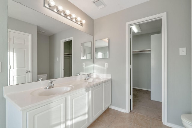 17139 Oakwood Chase Dr, Spring, TX 77379 - bathroom featuring toilet, tile patterned flooring, double vanity, and a spacious closet