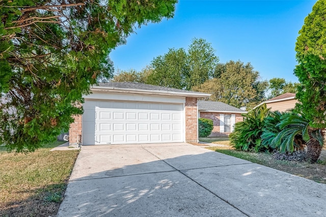 7650 Smiling Wood Ln, Houston, TX 77086 - view of front facade featuring brick siding, driveway, and a garage
