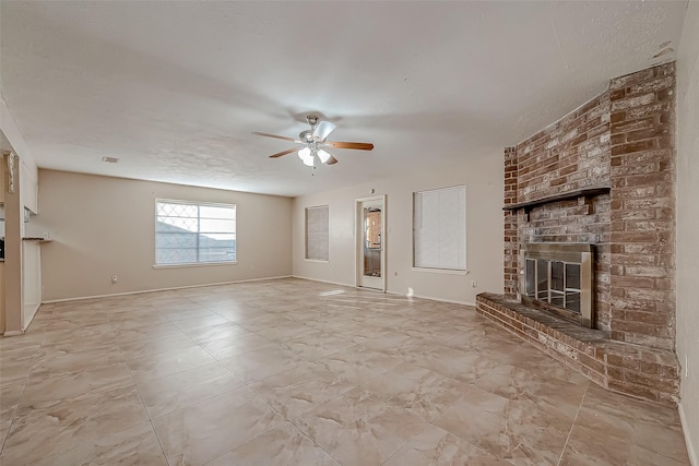 7650 Smiling Wood Ln, Houston, TX 77086 - unfurnished living room featuring a ceiling fan, a brick fireplace, and baseboards