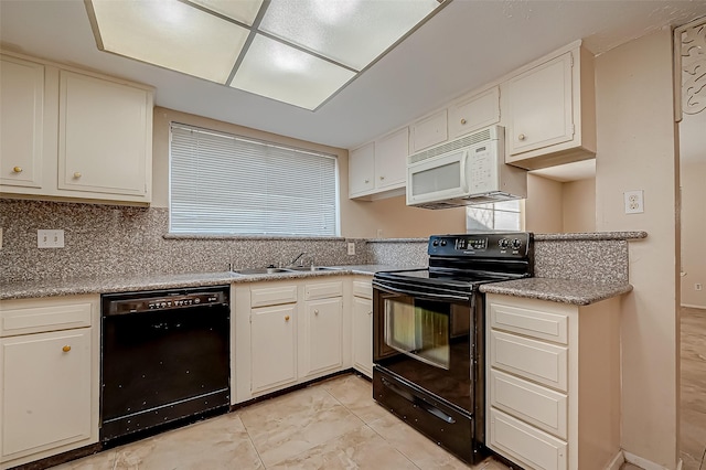 7650 Smiling Wood Ln, Houston, TX 77086 - kitchen featuring black appliances, a sink, light countertops, backsplash, and white cabinetry