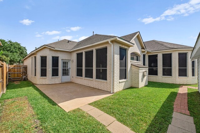 1803 Mustang Xing, Missouri City, TX 77459 - rear view of house featuring roof with shingles, a patio, and brick siding