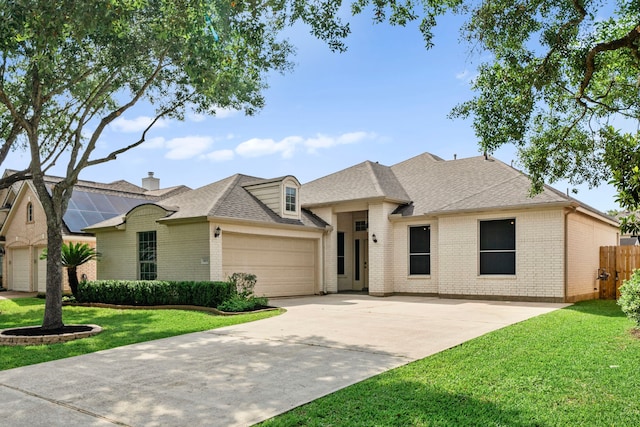 1803 Mustang Xing, Missouri City, TX 77459 - view of front of home featuring brick siding, a garage, concrete driveway, roof with shingles, and a chimney