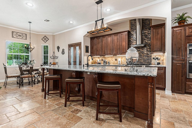 1827 E Cedar Bayou Lynchburg Rd, Baytown, TX 77521 - kitchen featuring stone tile floors, recessed lighting, decorative backsplash, a center island with sink, and a kitchen bar