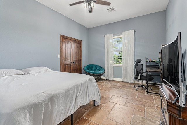 1827 E Cedar Bayou Lynchburg Rd, Baytown, TX 77521 - bedroom featuring stone tile flooring, a desk, baseboards, and ceiling fan
