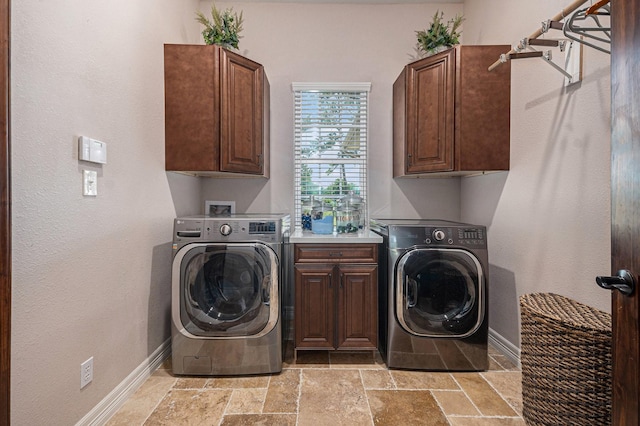 1827 E Cedar Bayou Lynchburg Rd, Baytown, TX 77521 - laundry room with cabinet space, stone tile floors, baseboards, and washer and dryer
