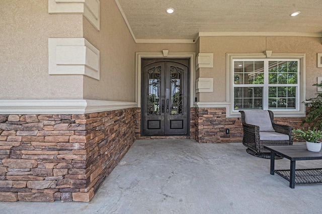 1827 E Cedar Bayou Lynchburg Rd, Baytown, TX 77521 - property entrance featuring french doors, stone siding, and stucco siding