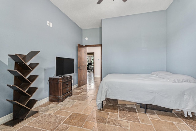 1827 E Cedar Bayou Lynchburg Rd, Baytown, TX 77521 - bedroom with stone tile floors, high vaulted ceiling, baseboards, and a ceiling fan