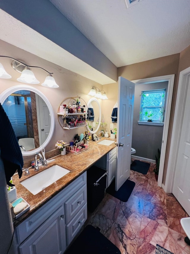 6639 Seaton Valley Dr, Spring, TX 77379 - bathroom with double vanity, toilet, and marble finish floors
