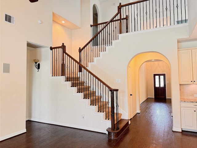 19823 Molly Winters Ln, Cypress, TX 77433 - stairway featuring wood finished floors, a towering ceiling, and arched walkways