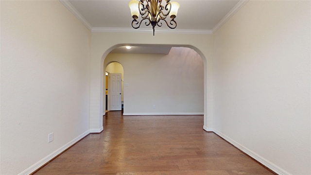 19823 Molly Winters Ln, Cypress, TX 77433 - unfurnished dining area with arched walkways, ornamental molding, wood finished floors, and a chandelier