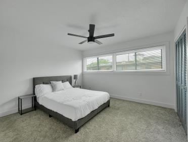 3809 N Braeswood Unit 14, Houston, TX 77025 - carpeted bedroom with baseboards and ceiling fan