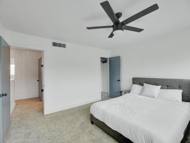3809 N Braeswood Unit 14, Houston, TX 77025 - bedroom featuring carpet, a ceiling fan, and baseboards