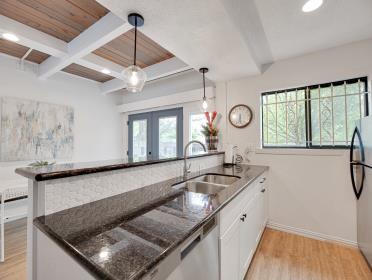 3809 N Braeswood Unit 14, Houston, TX 77025 - kitchen featuring a sink, freestanding refrigerator, light wood-type flooring, beam ceiling, and french doors