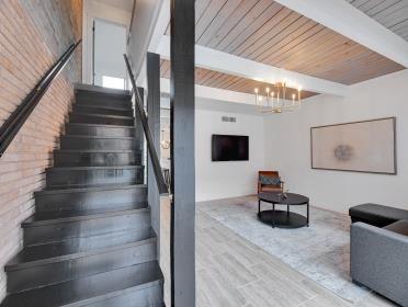 3809 N Braeswood Unit 14, Houston, TX 77025 - staircase featuring a chandelier and wood ceiling with exposed beams