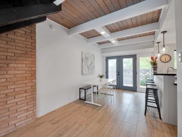 3809 N Braeswood Unit 14, Houston, TX 77025 - entryway featuring french doors, wood finished floors, and wood ceiling with exposed beams