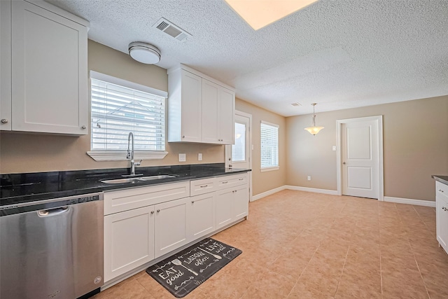 3705 Autumn Ln, Baytown, TX 77521 - kitchen featuring dishwasher, a sink, dark countertops, white cabinetry, and a textured ceiling