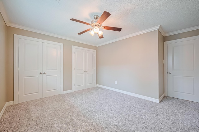 3705 Autumn Ln, Baytown, TX 77521 - unfurnished bedroom with carpet, multiple closets, baseboards, and crown molding