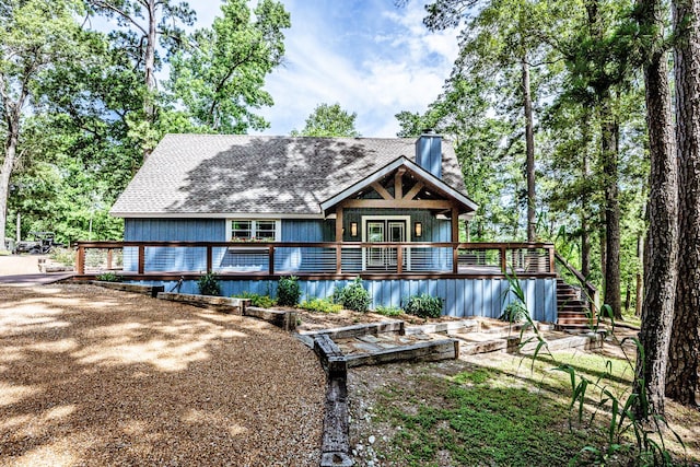 44 Post Oak Dr, Huntsville, TX 77320 - rear view of property featuring a chimney, a wooden deck, a shingled roof, and stairway
