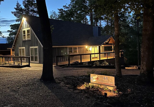 44 Post Oak Dr, Huntsville, TX 77320 - back of house with a shingled roof, a wooden deck, and board and batten siding