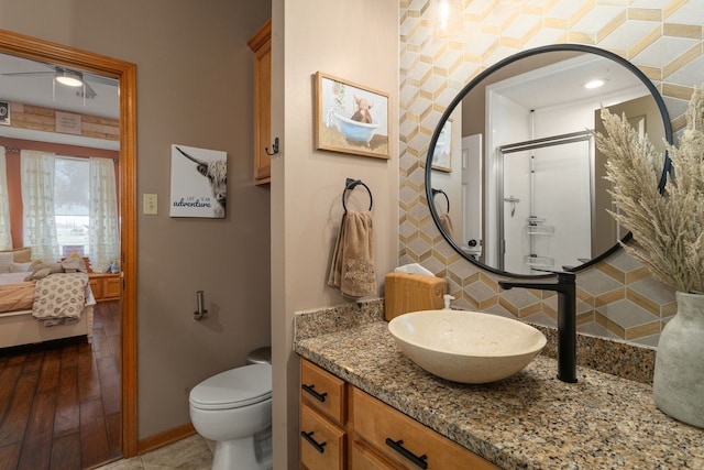 1802 Snow Goose Ln, Katy, TX 77493 - ensuite bathroom featuring tasteful backsplash, vanity, ceiling fan, baseboards, and toilet