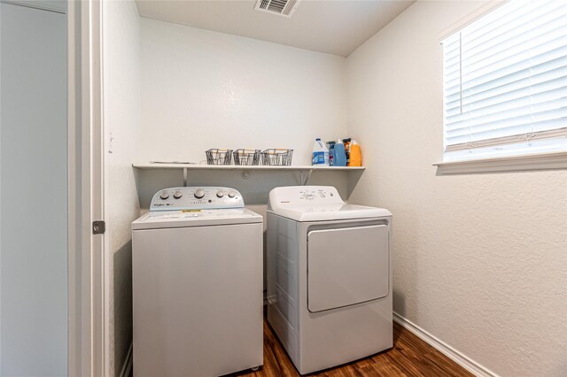 3240 Mission Riv, San Antonio, TX 78245 - washroom featuring washing machine and clothes dryer, dark wood-type flooring, and baseboards