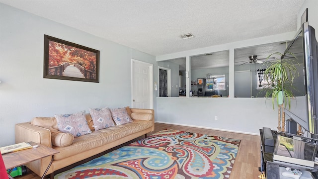 3814 Ripplebrook Dr, Houston, TX 77045 - living room with wood finished floors, a textured ceiling, and a ceiling fan